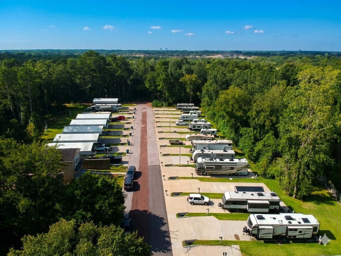 Aerial view of The Woodland RV Park in Conroe, Texas, surrounded by woods